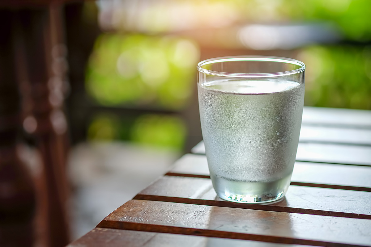 Water glass on wooden table.